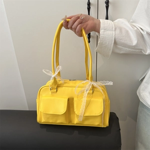 Bright yellow pillow shoulder bag with white lace bows and double front pockets