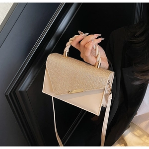 Detail of luxury crossbody bag with sparkling rhinestone flap and woven rope handle