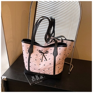 Detail of pink bubble texture fabric and black bow design on the large tote bag