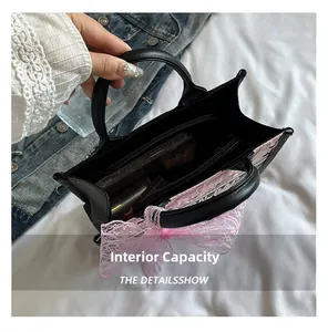 Detail view of the spacious black tote bag interior with a functional zipper pocket