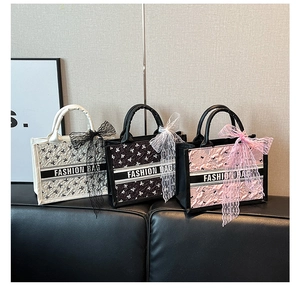 Detailed view of quilted tote bags in beige black and pink with lace bow decorations