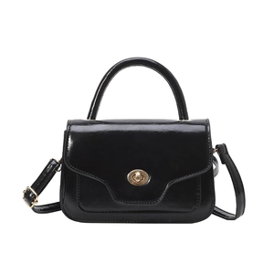 Classic black glossy saddle bag with gold oval twist lock and adjustable shoulder strap