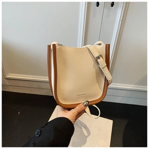 Detail of premium lychee grain leather crossbody bucket bag with HELENBOB logo
