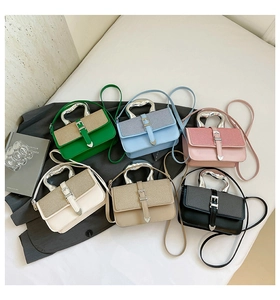 Close-up of candy-colored crossbody bags with fluid silver handles and heart detail