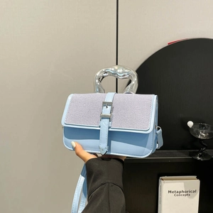Chic light blue crossbody bag with metallic top handle and silver buckle detail