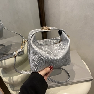 Silver snakeskin textured pillow bag with metallic finish and gold buckle detail
