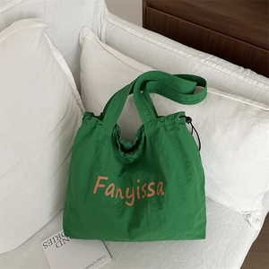 Lightweight bright green nylon tote bag with drawstring closure and textured finish