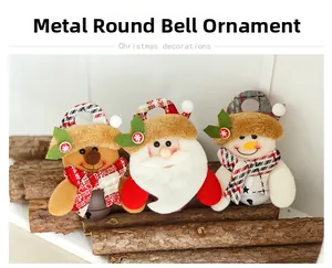 Detail of Christmas metal bell ornaments with reindeer and snowman fabric plush heads