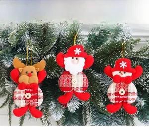 Detail of Christmas plush ornaments with Santa, Snowman and Reindeer on a tree branch