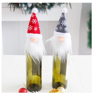 Détail de couvre-bouteilles de vin nains rouge et gris avec chapeaux en tricot et flocons