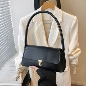 Chic black rectangular underarm bag with gold metal clasp for summer 2025 fashion