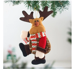 Close-up of a reindeer plush ornament with a red scarf hanging on a green Christmas tree