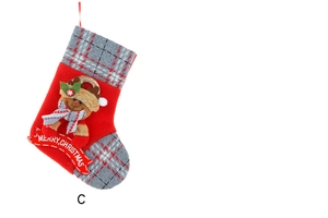 Detail of red Christmas stocking with 3D reindeer doll and Merry Christmas banner