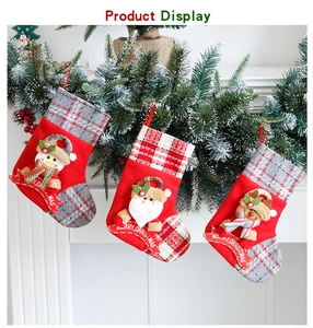 Three Christmas stockings with Santa, Snowman, and Reindeer hanging on a fireplace mantel