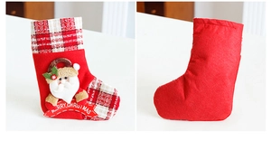 Detailed front and back view of red Christmas stocking with Santa Claus and plaid trim