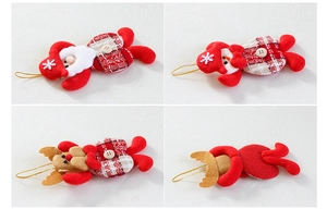 Detail of red plush Santa, snowman and elk ornaments with white snowflakes and gold cords