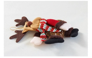 Close-up of Christmas reindeer doll hanging ornament with red scarf and gold string