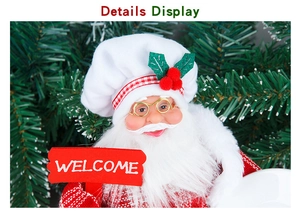 Detailed view of Chef Santa Claus doll holding a red Welcome sign with holly berry hat