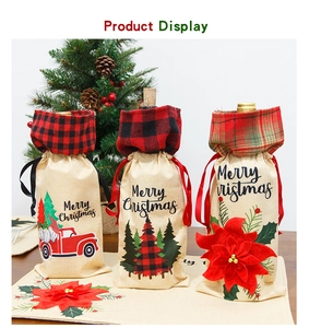 Three linen Christmas wine bottle gift bags with plaid collars and festive motifs