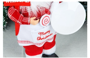 Close-up of Chef Santa figurine holding a white tray with Merry Christmas embroidery