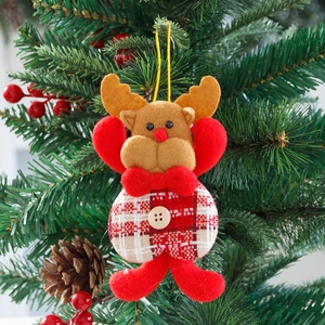 Red checkered reindeer plush ornament with wooden button hanging on a Christmas tree
