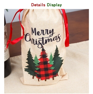 Detail view of burlap wine bottle bag with Merry Christmas text and plaid tree pattern