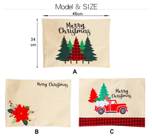 Detailed view of three festive linen placemats showing vintage truck and tree patterns