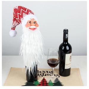 Detail of Santa Claus wine bottle cover with knitted hat and plush beard for table decor
