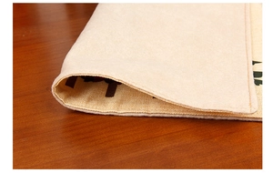 Detail of linen placemat showing non-slip felt backing and double-layer stitched edges