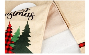 Detail of Christmas table runner fabric showing linen texture and Merry Christmas print