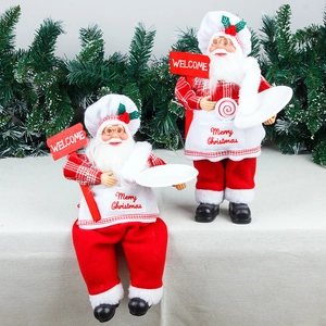 Standing and sitting Santa Claus chef figurines with Welcome sign and Merry Christmas apron