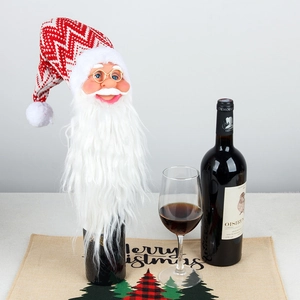 Knitted Santa Claus wine bottle cover with long white beard and gold spectacles