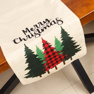 Linen Christmas table runner with Merry Christmas lettering and tree prints on wood