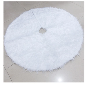 Detail of white faux fur Christmas tree skirt with long plush texture and soft round design