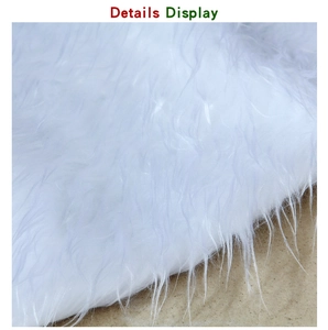 Close-up of pure white faux fur Christmas tree skirt showing soft long plush texture