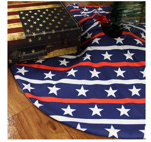 Detail of American flag tree skirt with stars and stripes on a dark wood floor