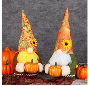 Detail of harvest gnomes with sunflower hats holding miniature pumpkins for Thanksgiving