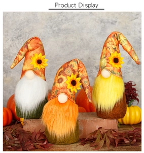 Detailed view of three sunflower gnomes with vibrant orange and yellow plush beards