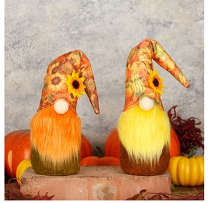 Close-up of Thanksgiving gnomes with sunflower hats and plush beards on a fall background