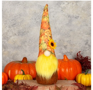 Detail of harvest gnome featuring long yellow beard and pumpkin patterned tall hat