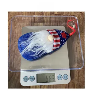 Detail view of Independence Day gnome pendant weighing 56.3g on an electronic scale