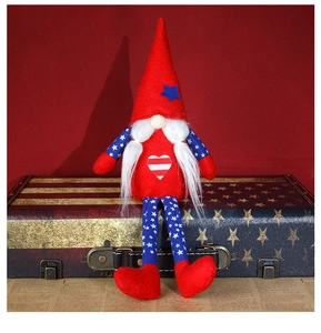 Detailed view of patriotic long-legged gnome doll sitting on a vintage stars and stripes suitcase