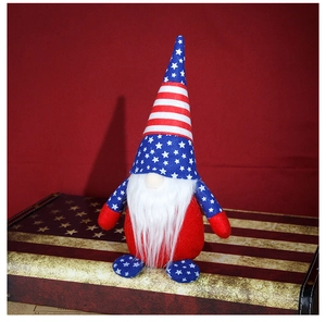 Close-up of patriotic gnome with stars and stripes hat on a vintage flag suitcase