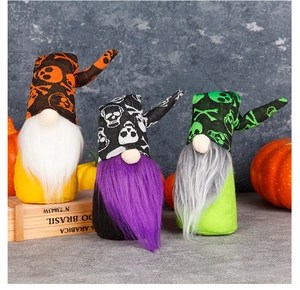 Three Halloween gnomes with skull prints and colorful beards on a pumpkin display