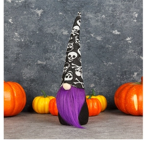 Detail of Halloween gnome with skull hat and purple beard among festive pumpkins