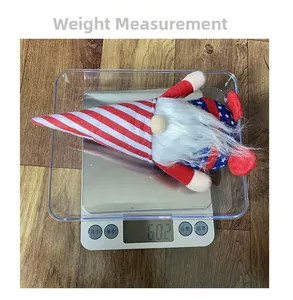 Detail view of Independence Day gnome on a scale showing a weight of 60.2g