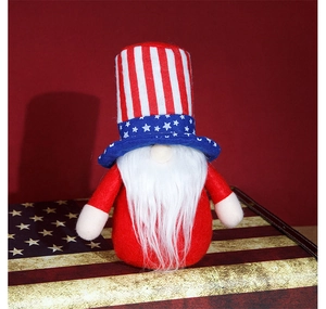 Detail of 4th of July Independence Day gnome with striped hat on flag suitcase