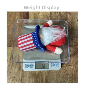 Close-up of patriotic USA gnome plush being weighed on an electronic scale at 60.0g