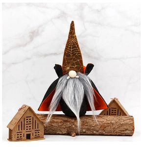 Detail of Halloween gnome wizard doll with spider web hat and black cloak on wood