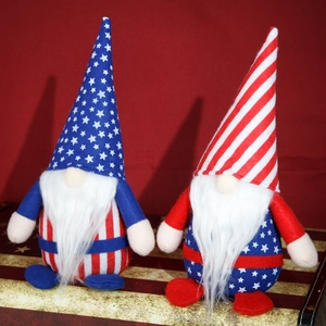 Pair of USA Independence Day gnomes with stars and stripes patterns on a red background